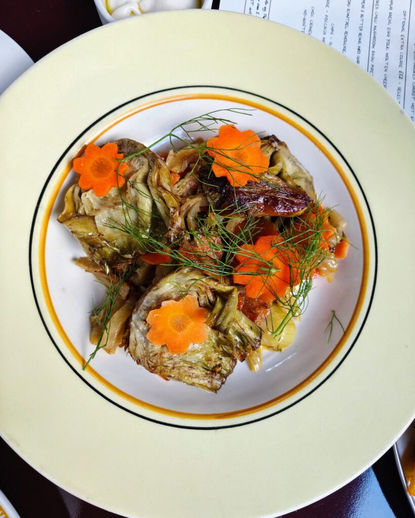 Charred Artichoke - Carrot and fennel braise, aioli at Holy Carrot Bistro